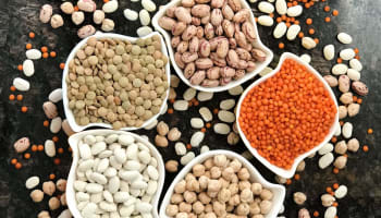 a group of different types of beans in bowls