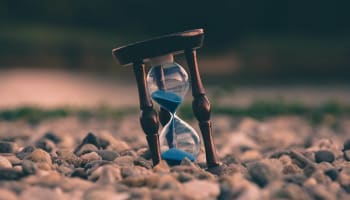 an hourglass on rocks