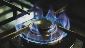 a blue flame on a stove