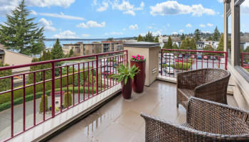 a balcony with a view of a city and water