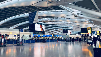 a large airport with people walking around