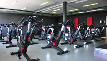 a group of exercise bikes in a gym