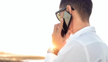 a person holding a cell phone to his ear