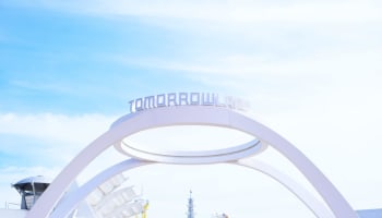 a white arch with a sign above it