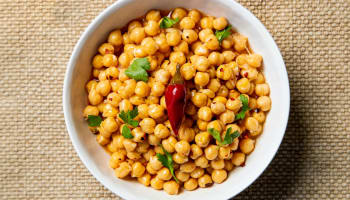 a bowl of chickpeas with a chili pepper