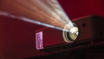 a projector with a light coming out of the lens