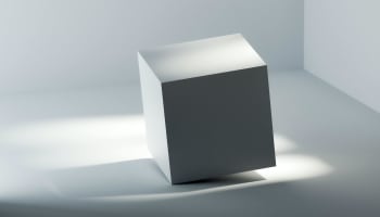 a white cube with a light shining on it