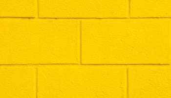 a yellow brick wall with a square pattern