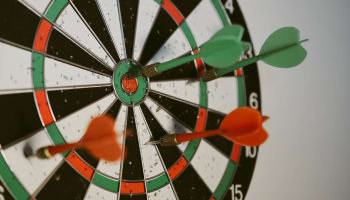 a dart board with arrows in the center