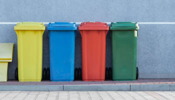 a row of colorful trash cans
