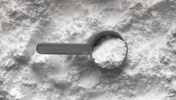 a measuring spoon with white powder