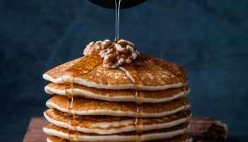 a stack of pancakes with syrup on top