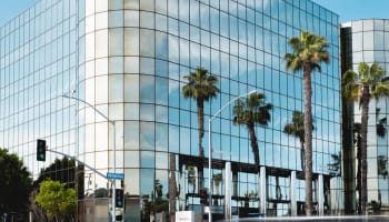 a building with palm trees in front of it