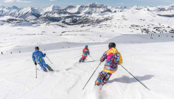 a group of people skiing down a mountain