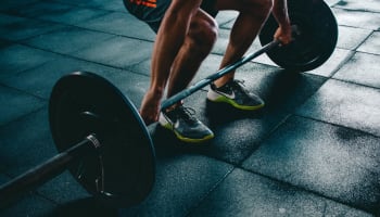 a person lifting weights on a gym floor