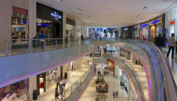 a large shopping mall with many shops and people