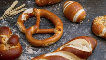 a pretzel and bread on a table