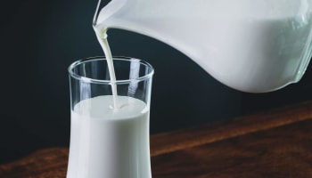 a glass of milk being poured into a glass