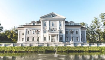 a large building with a fountain in front of it