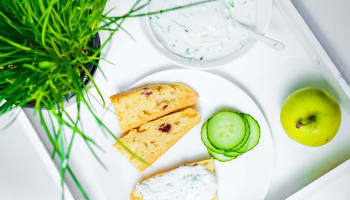 food on a plate next to a plant