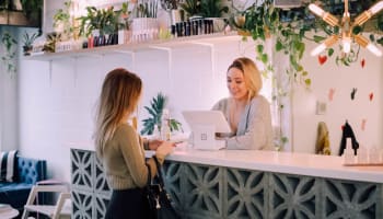 a person standing at a counter with a laptop