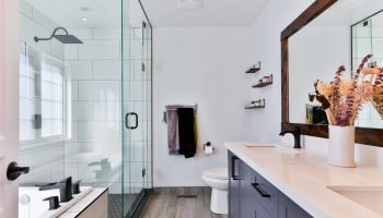 a bathroom with a glass shower and sink