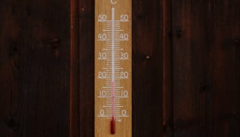 a thermometer on a wood surface