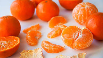a group of oranges on a white surface