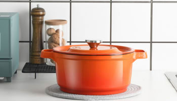 an orange pot on a counter