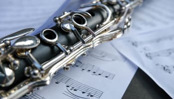 a clarinet on a sheet of music