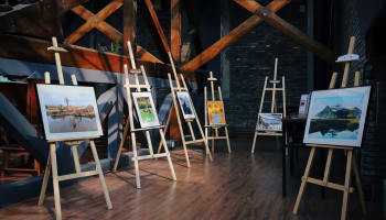 a group of easels with paintings on them
