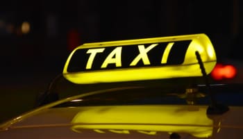 a taxi sign on a car