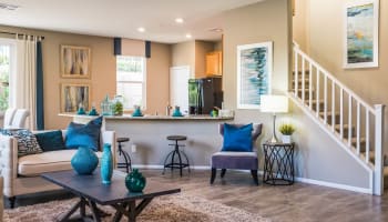 a living room with a table and chairs