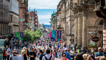 a crowd of people walking down a street