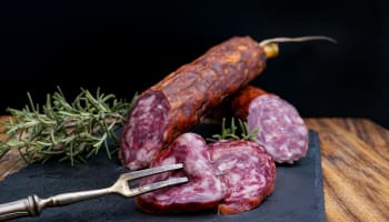 a fork and sliced salami