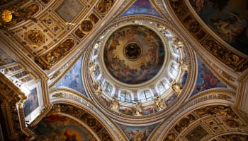 a ceiling with gold trim and paintings
