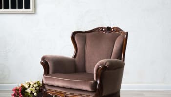 a chair and basket of flowers