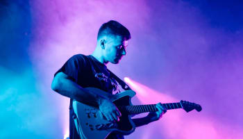 a person playing a guitar on a stage