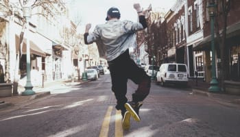 a person jumping in the air on a street