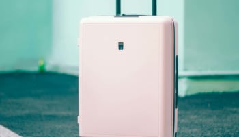 a pink suitcase on wheels