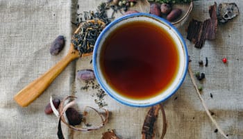 a cup of tea with a wooden spoon