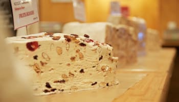 a large white cake with nuts on it