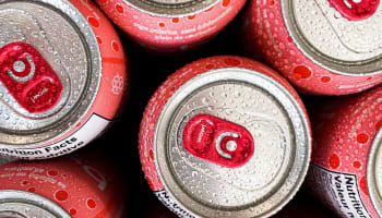 a group of cans with water droplets