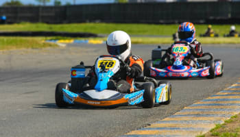 a group of people driving go karts on a track