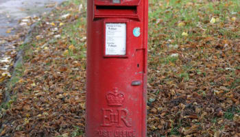 a red mailbox on the ground