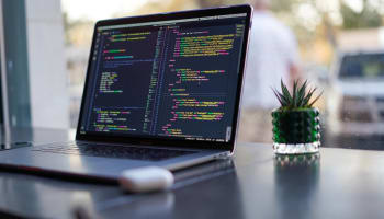 a laptop with colorful text on screen