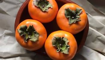 a bowl of persimmons