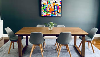 a dining room table with chairs and a chandelier