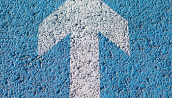 a blue and white arrow painted on a blue surface