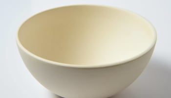 a white bowl on a white surface